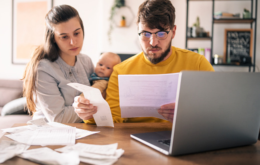 Family Calculating Their Monthly Expenses Stock Photo Download Image