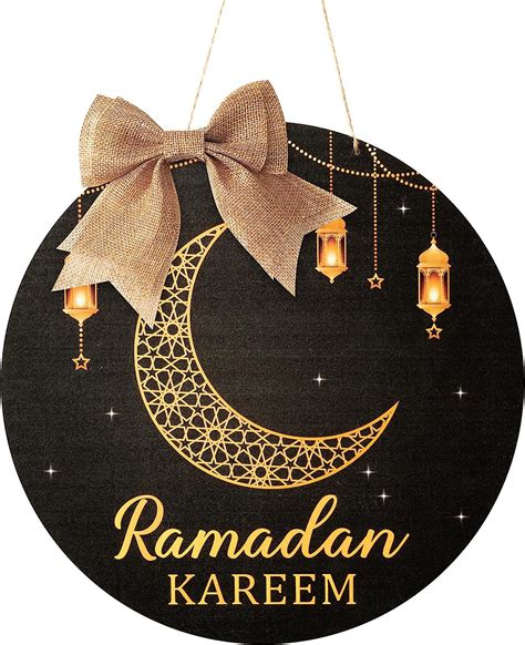 The Ramaan Kareem Sign Is Hanging From Strings With Gold Lettering On It