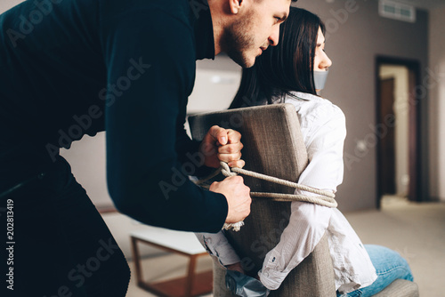 Tortured Man In A Chair With Tied Hands Sepia Tone Stock Photo By